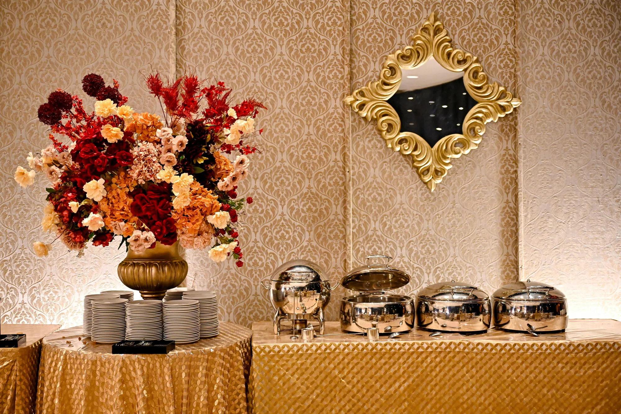 Premium wedding buffet laid out with chafing dishes and floral styling