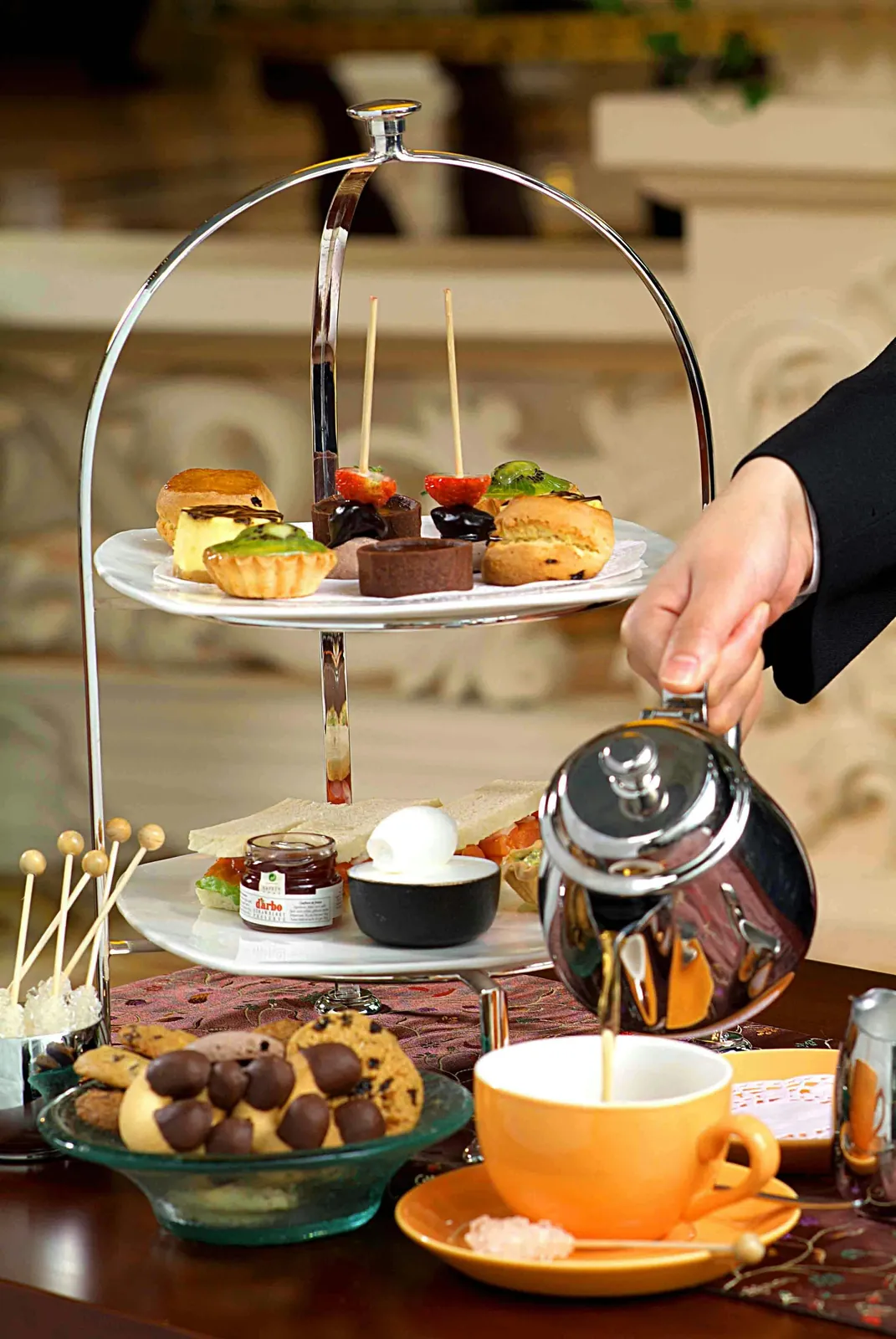 Hi-tea stand with pastries and tea service