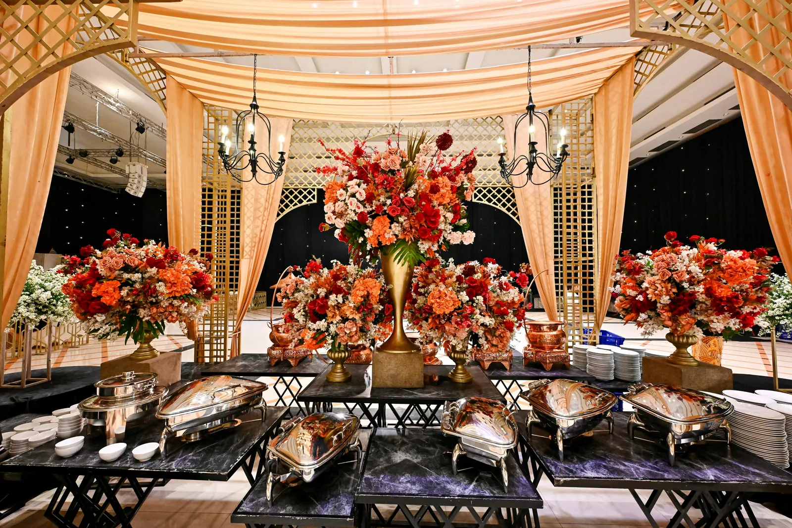 Wedding reception dining hall styled with florals and buffet counters